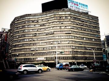 a old old buiding on a busy intersection.  it had been around forever